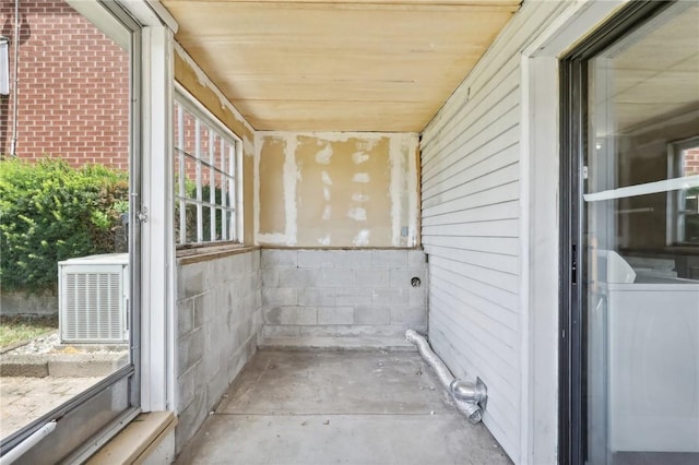 unfurnished sunroom with washer / dryer and wooden ceiling