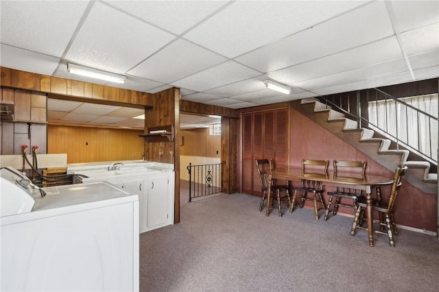 washroom with washer / dryer, wooden walls, and carpet flooring