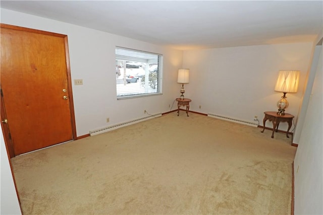 interior space with carpet floors and a baseboard heating unit