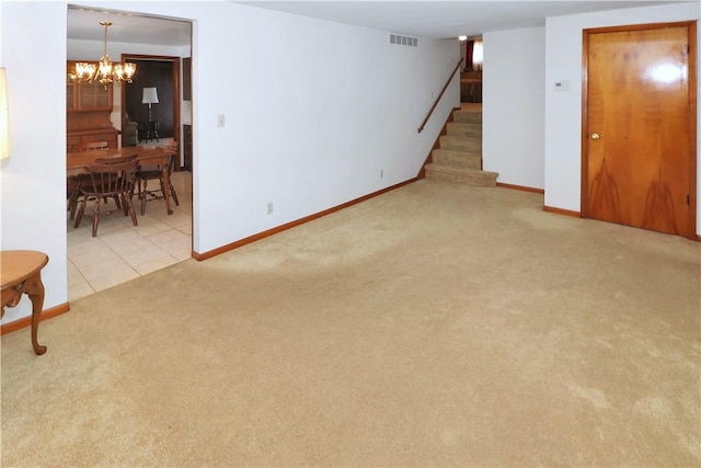 carpeted living room with a notable chandelier