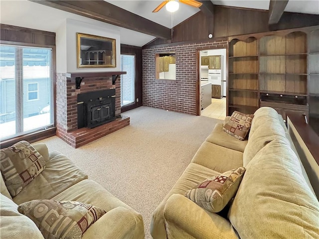 living room featuring ceiling fan, light colored carpet, brick wall, and a wood stove