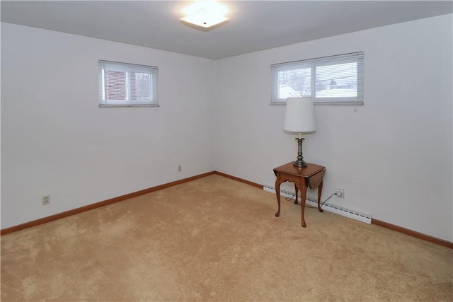 carpeted spare room with a baseboard radiator