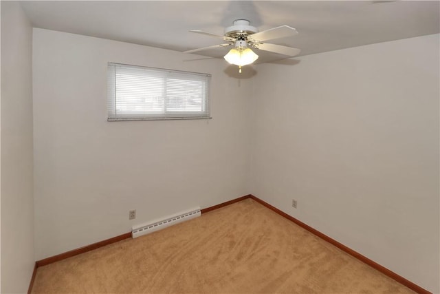 empty room with ceiling fan, a baseboard heating unit, and carpet flooring