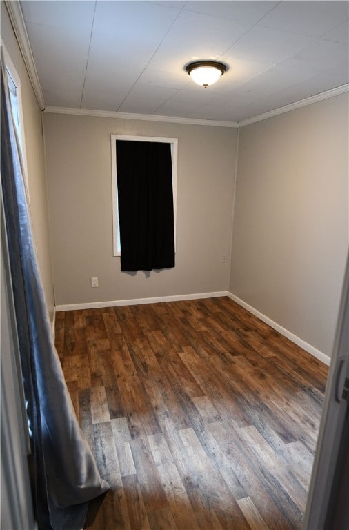 empty room featuring crown molding and hardwood / wood-style floors