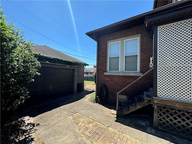 view of home's exterior featuring an outbuilding and a garage