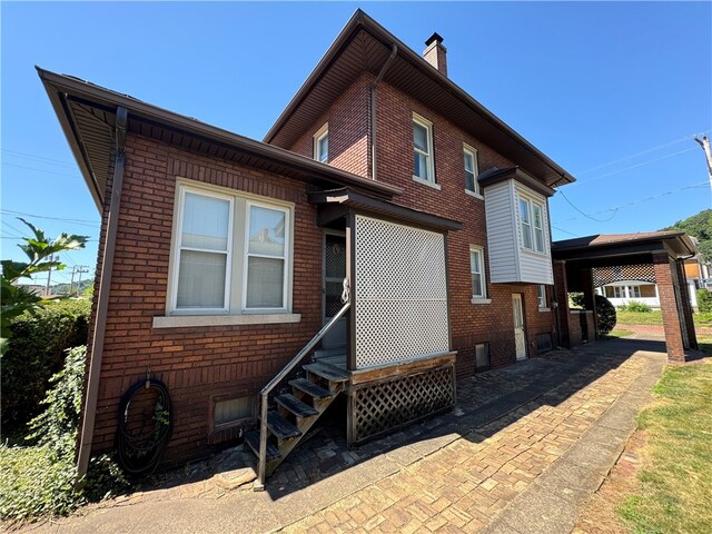 back of property with a carport