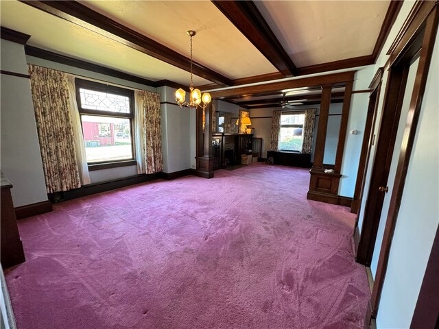 unfurnished dining area with carpet, ceiling fan with notable chandelier, ornamental molding, and beamed ceiling