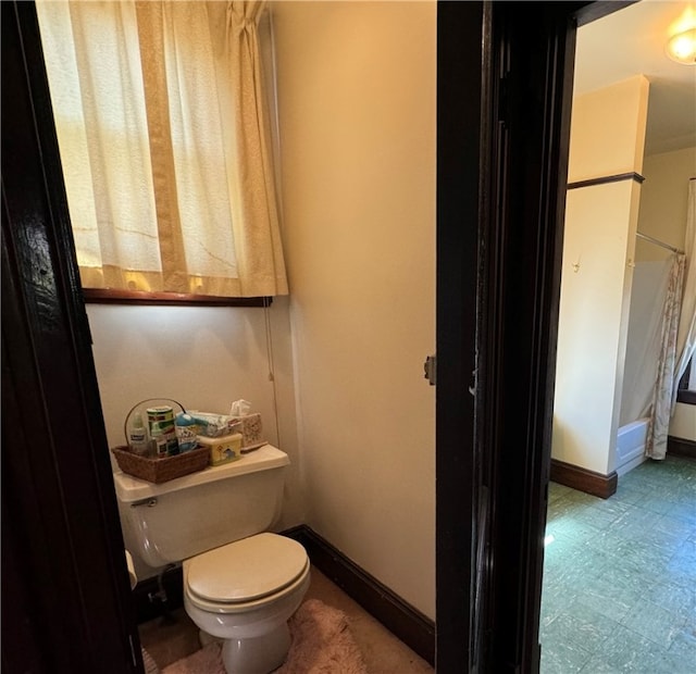 bathroom featuring tile patterned flooring and toilet