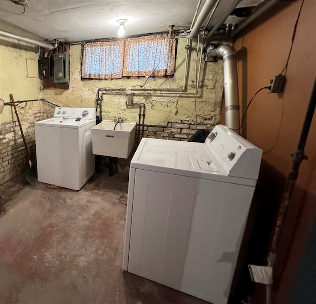 clothes washing area featuring sink, electric panel, and separate washer and dryer