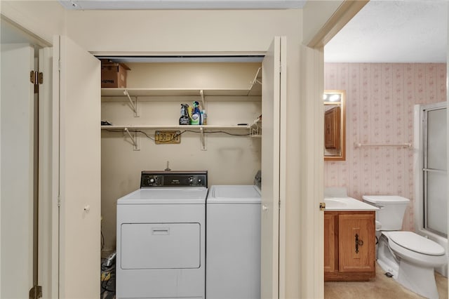 clothes washing area with separate washer and dryer