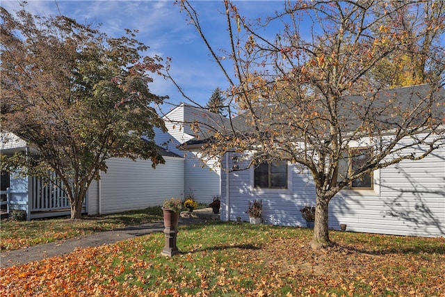 view of property exterior with a lawn