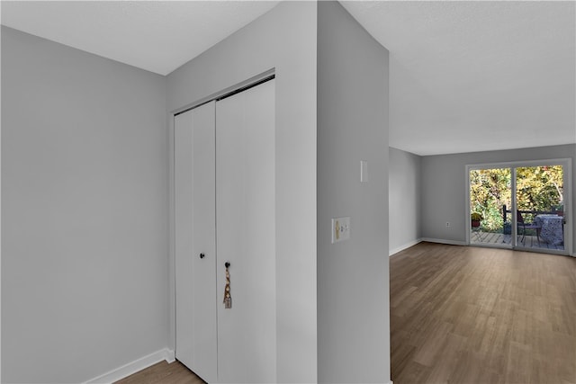 interior space with a closet, a textured ceiling, and hardwood / wood-style flooring