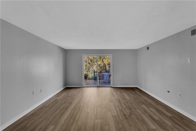 empty room featuring dark hardwood / wood-style flooring