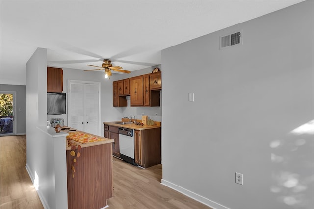 kitchen with dishwasher, sink, light wood-type flooring, and ceiling fan