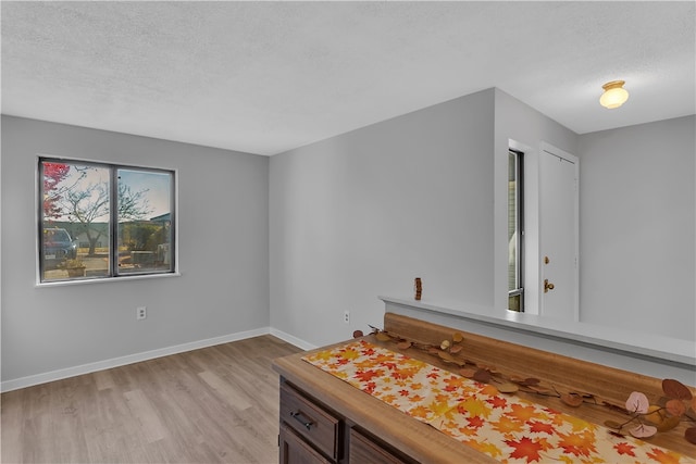 bathroom with hardwood / wood-style floors and a textured ceiling