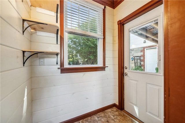 doorway featuring wood walls