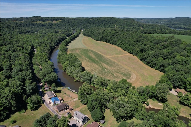 aerial view featuring a forest view and a water view