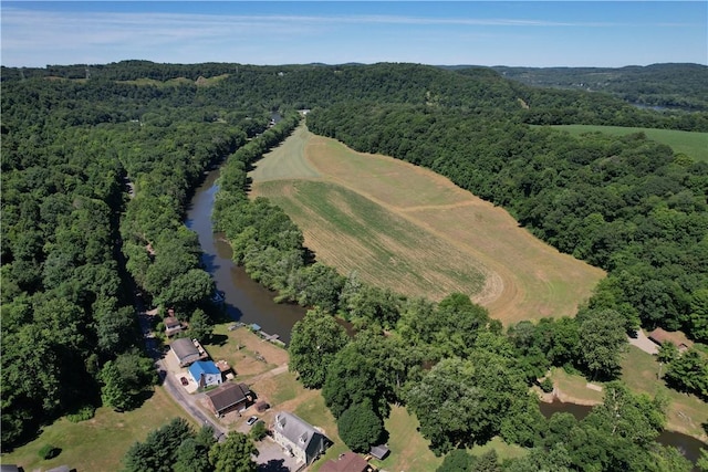 aerial view with a wooded view and a water view