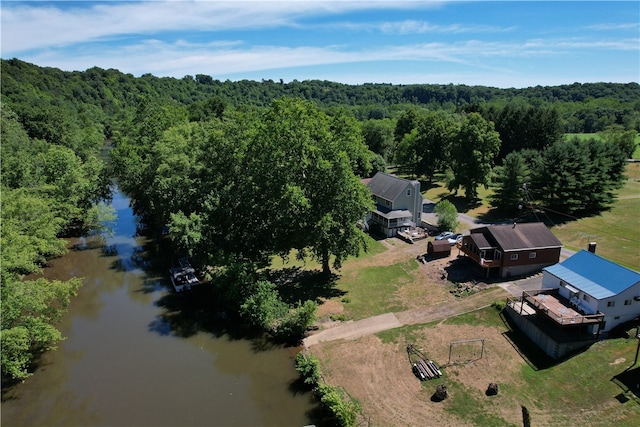 birds eye view of property with a forest view and a water view