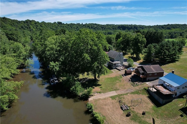 aerial view featuring a wooded view and a water view