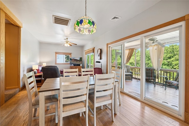 dining space featuring wood-type flooring and ceiling fan