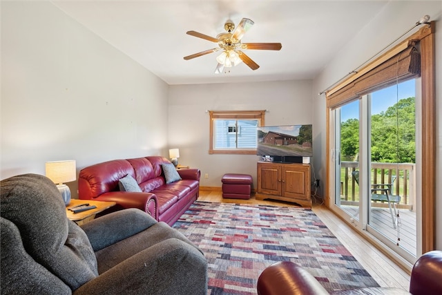 living room featuring light hardwood / wood-style floors and ceiling fan