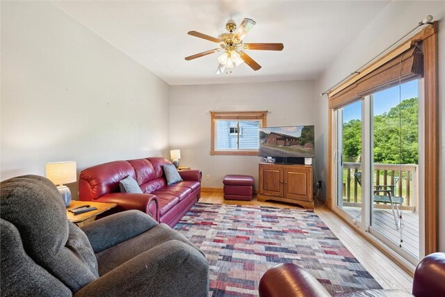 living room featuring ceiling fan and light wood finished floors