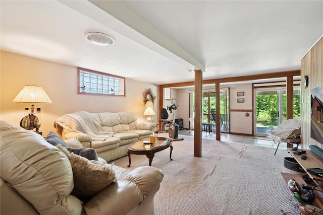 living room featuring light colored carpet and a healthy amount of sunlight
