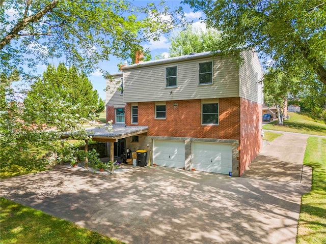 rear view of house featuring a garage