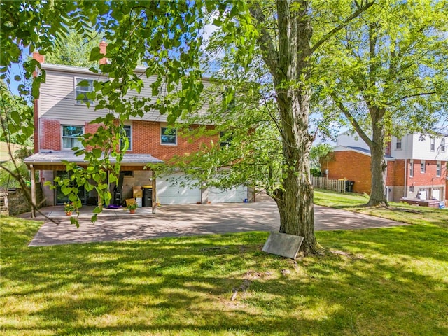 back of house with a garage and a lawn