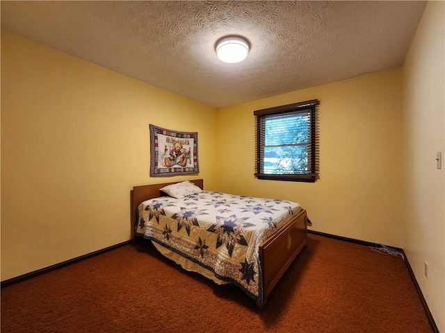 carpeted bedroom with a textured ceiling