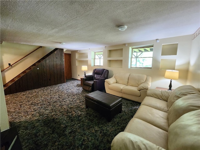 carpeted living room featuring a textured ceiling