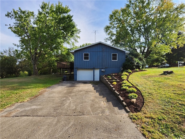 view of home's exterior with a deck, a garage, and a lawn