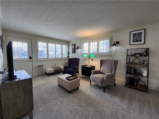 living room with ornamental molding and carpet