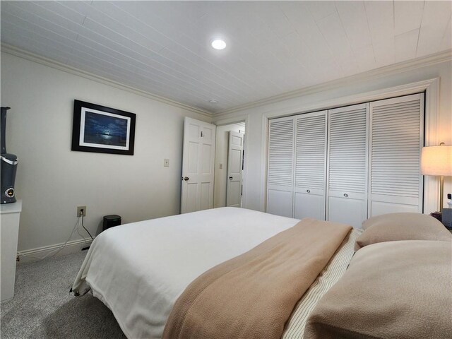 bedroom featuring a closet, carpet floors, and ornamental molding