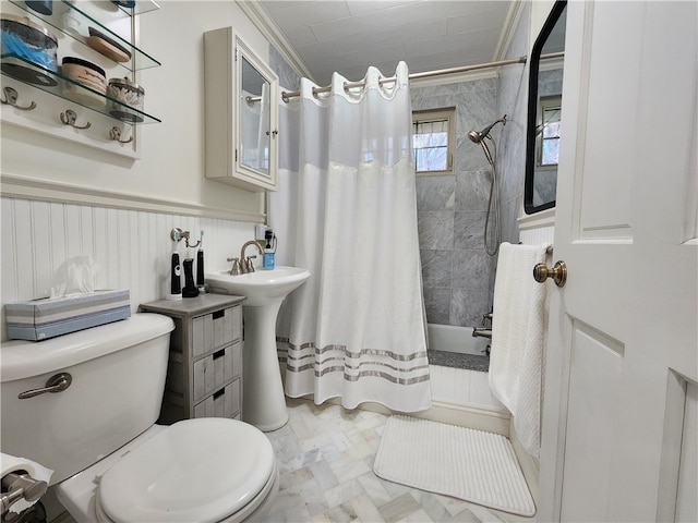 bathroom with tile patterned flooring, toilet, and ornamental molding