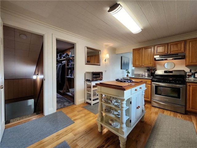 kitchen with wooden counters, light hardwood / wood-style floors, stainless steel range oven, and ornamental molding