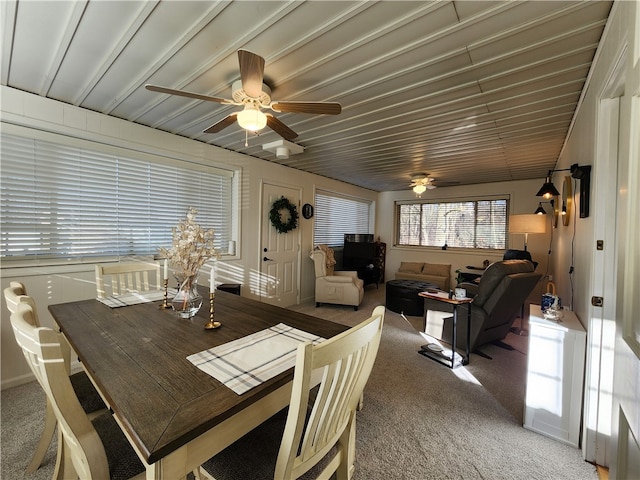 dining space with carpet and ceiling fan