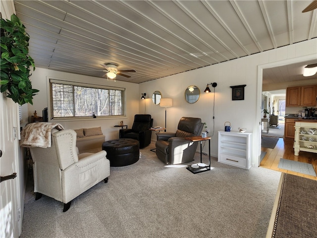 living room featuring carpet and ceiling fan