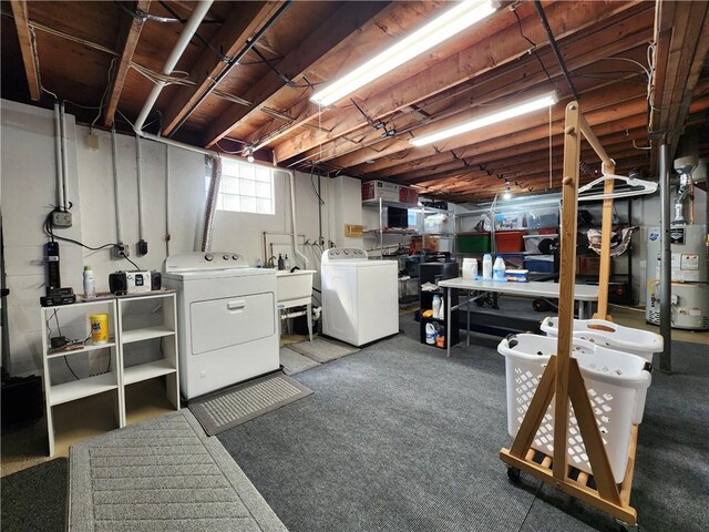 basement featuring sink, washer and dryer, and carpet