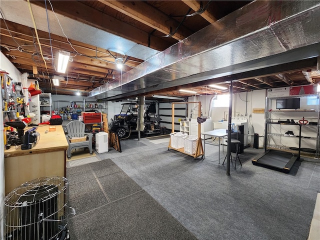 basement with washer / clothes dryer and a workshop area