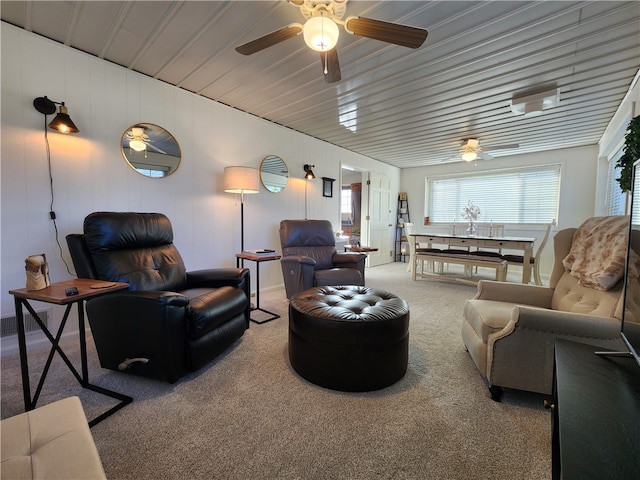 carpeted living room with ceiling fan