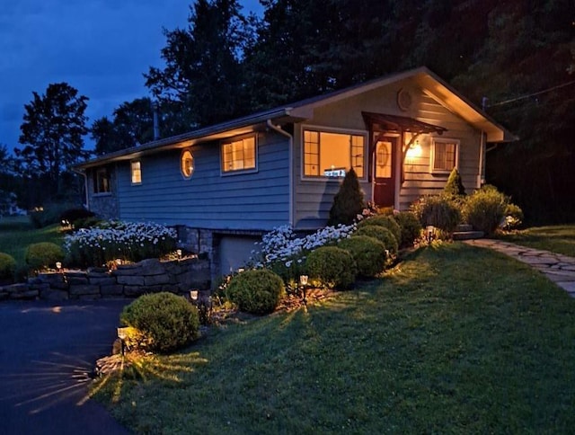 view of front of house with a garage and a front lawn