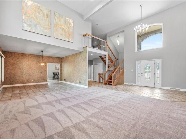 unfurnished living room featuring light carpet, a high ceiling, and an inviting chandelier