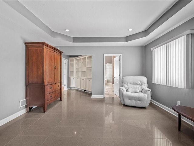 sitting room featuring a raised ceiling