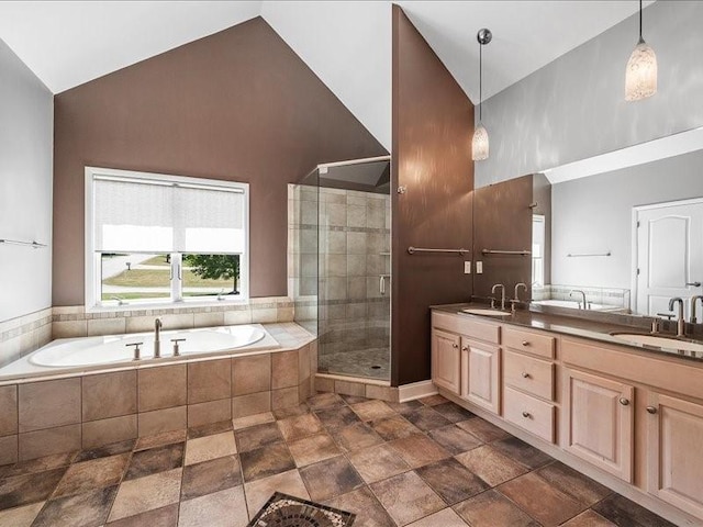 bathroom featuring plus walk in shower, vanity, and vaulted ceiling