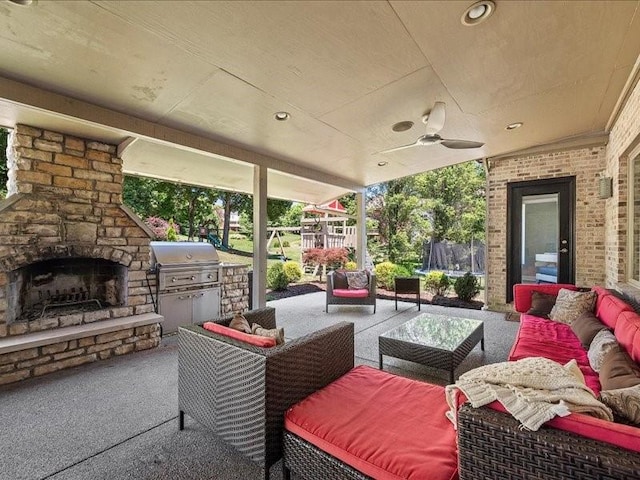 view of patio featuring an outdoor living space with a fireplace, ceiling fan, area for grilling, and a trampoline