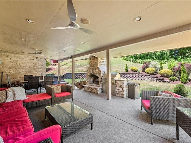 view of patio / terrace with an outdoor living space with a fireplace and ceiling fan