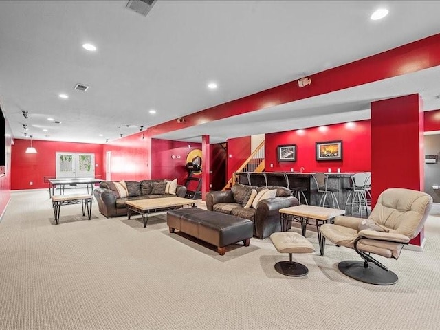 interior space featuring light colored carpet and bar