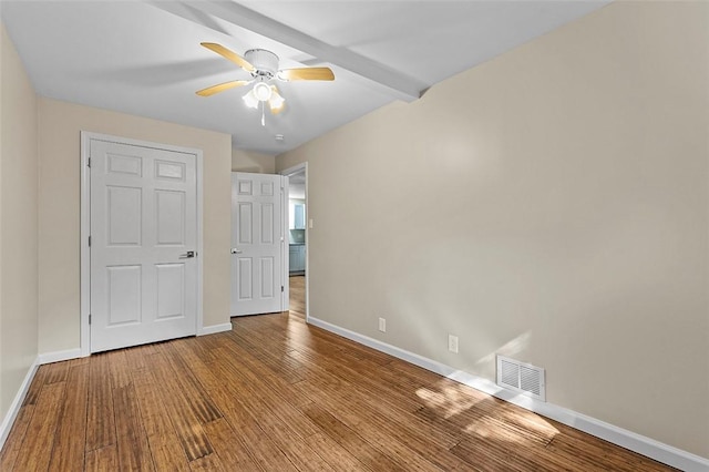 unfurnished bedroom with light wood-type flooring, ceiling fan, and beam ceiling